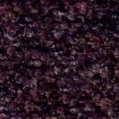 Textured fabric surface with irregular purplish-brown, beige, and tan tones, displaying a mottled, organic pattern and fuzzy granular detail.